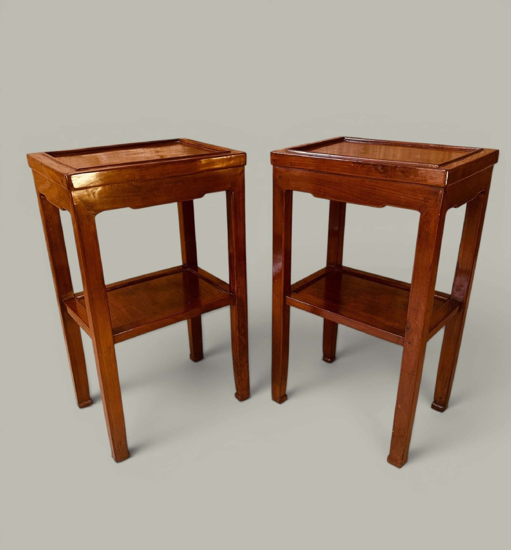 A pair of warm brown Chinese hardwood side tables featuring raised top borders, lower shelves, and straight square legs. View II