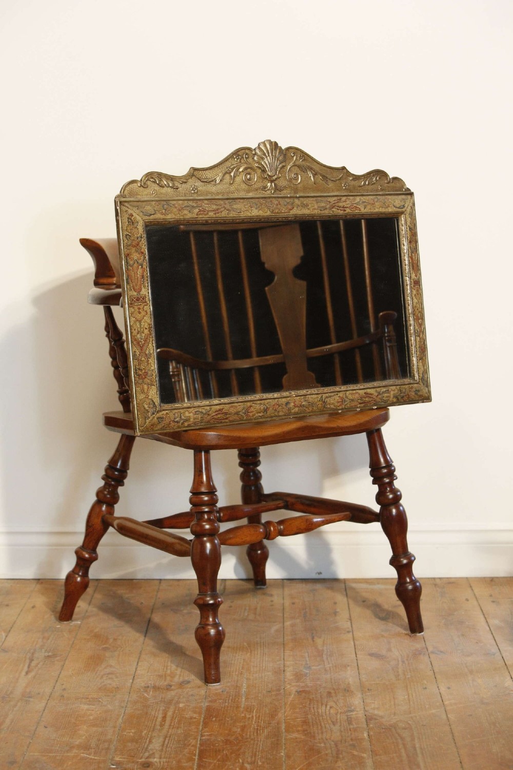 A 19th-century rectangular cushion wall mirror featuring an embroidered tapestry border, an ornamental gilt crest with a shell motif, and a glass plate. View II