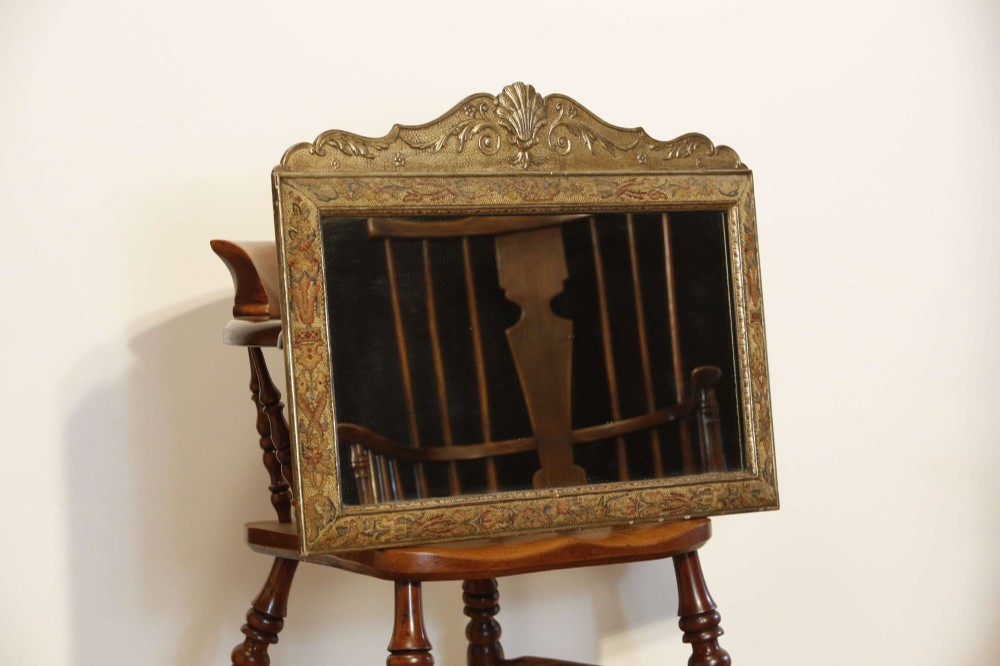 A 19th-century rectangular cushion wall mirror featuring an embroidered tapestry border, an ornamental gilt crest with a shell motif, and a glass plate. View III