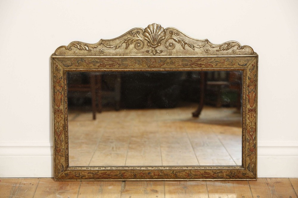 A 19th-century rectangular cushion wall mirror featuring an embroidered tapestry border, an ornamental gilt crest with a shell motif, and a glass plate. View VIII