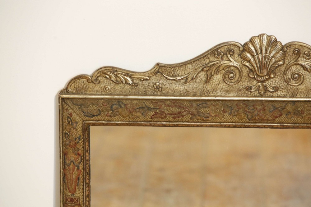 A 19th-century rectangular cushion wall mirror featuring an embroidered tapestry border, an ornamental gilt crest with a shell motif, and a glass plate. View IX
