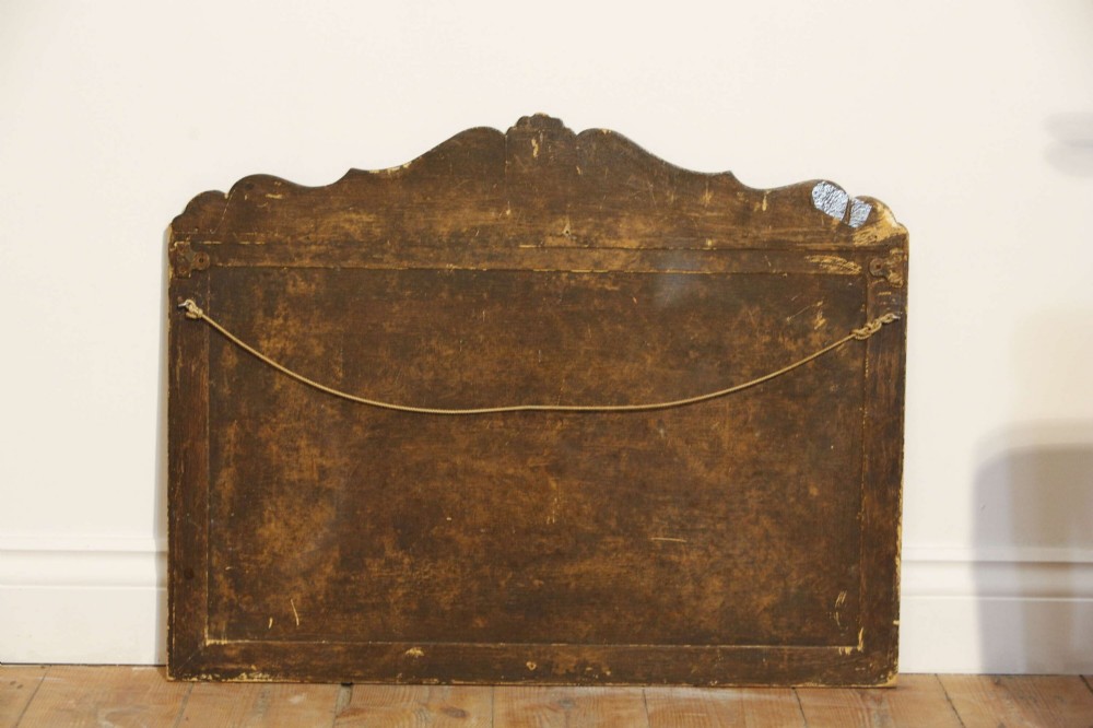 A 19th-century rectangular cushion wall mirror featuring an embroidered tapestry border, an ornamental gilt crest with a shell motif, and a glass plate. View XIII