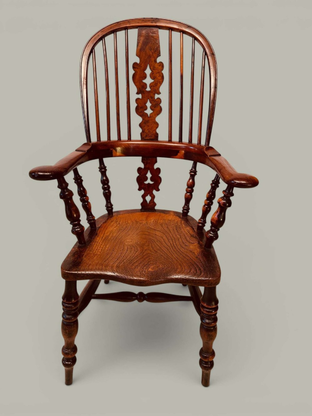 A pair of 19th-century yew and elm Windsor armchairs featuring curved hoop backs, pierced central splats, broad armrests, and turned legs. View II
