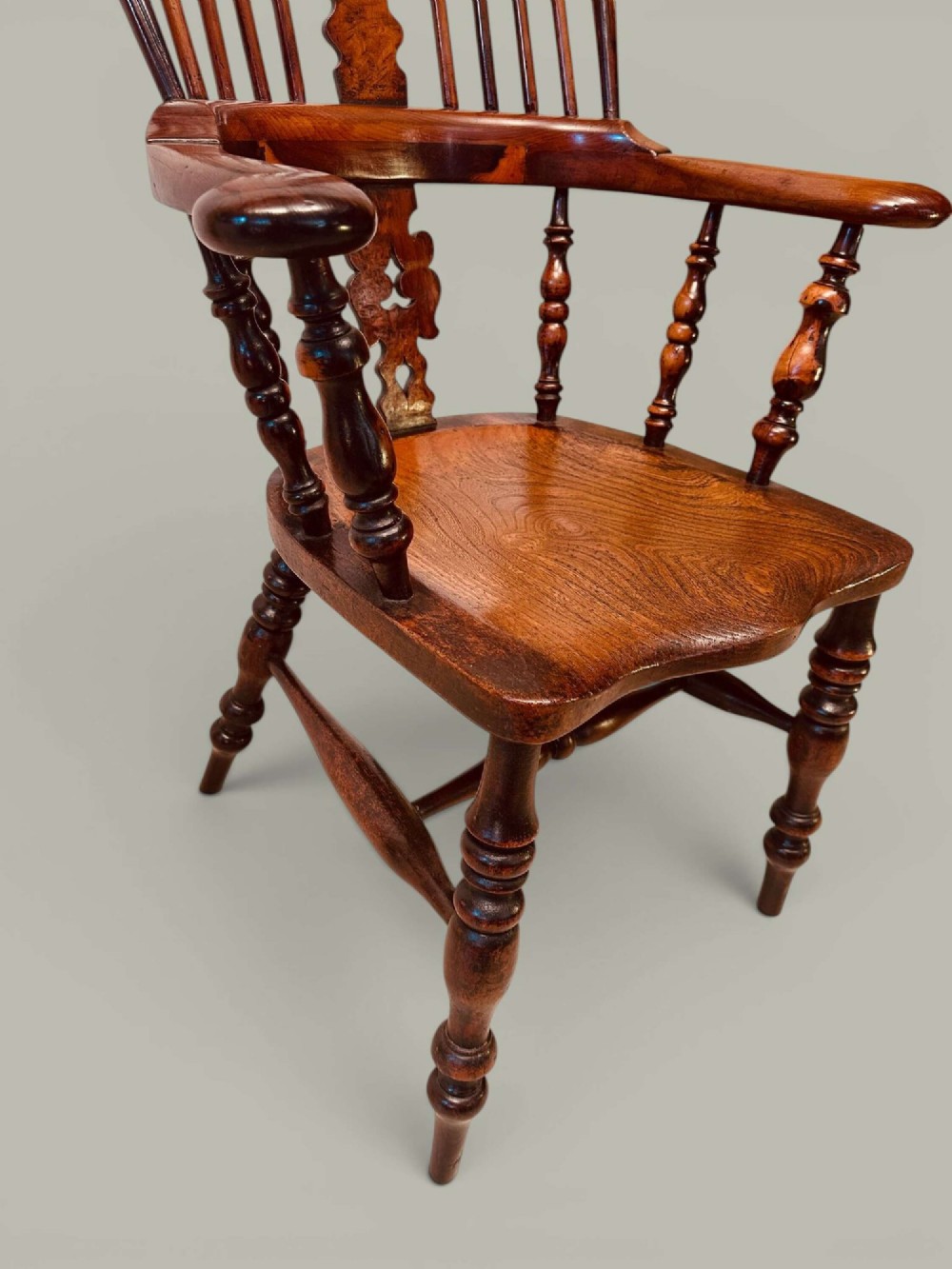 A pair of 19th-century yew and elm Windsor armchairs featuring curved hoop backs, pierced central splats, broad armrests, and turned legs. View VIII