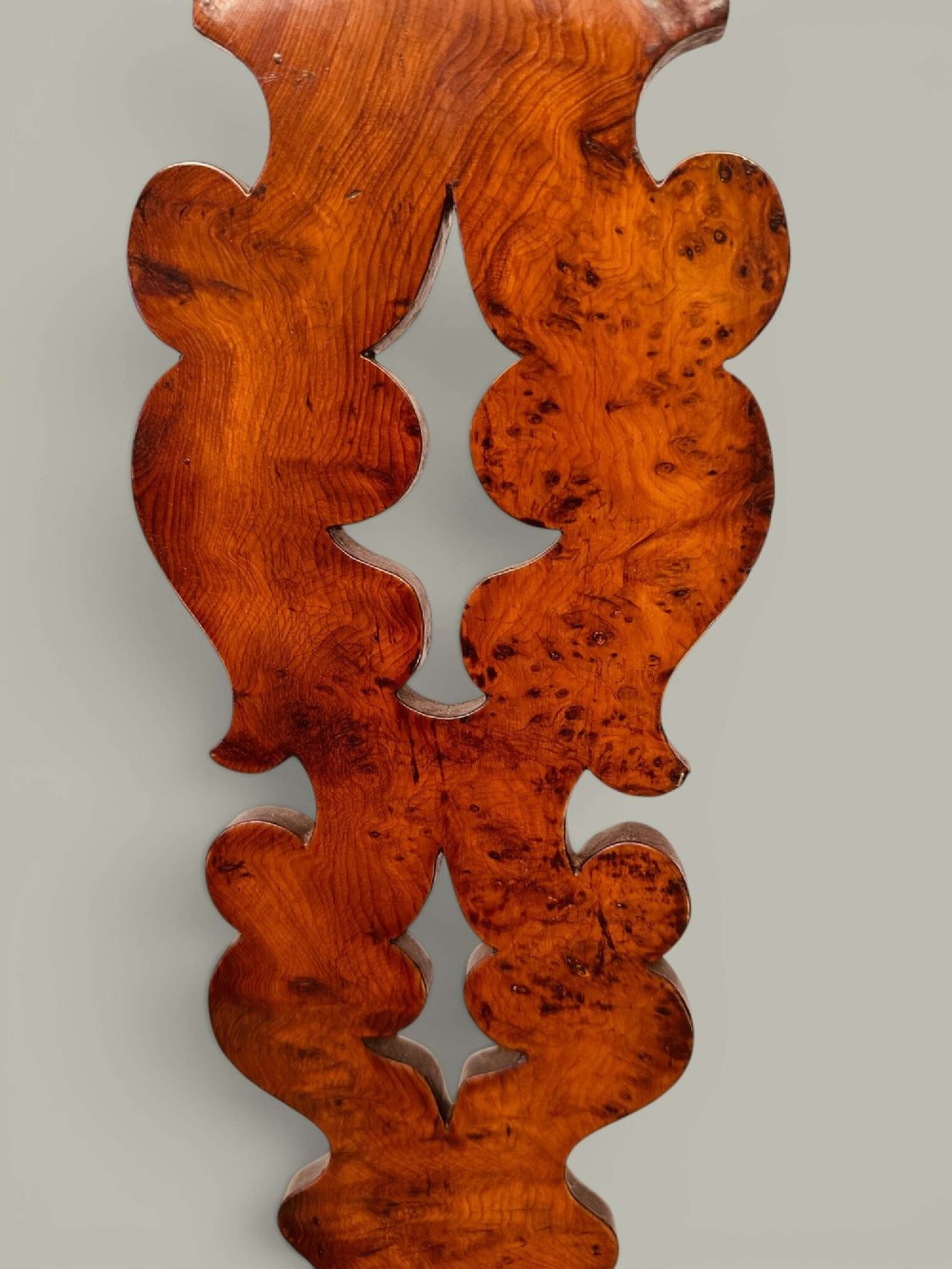 A pair of 19th-century yew and elm Windsor armchairs featuring curved hoop backs, pierced central splats, broad armrests, and turned legs. View IX