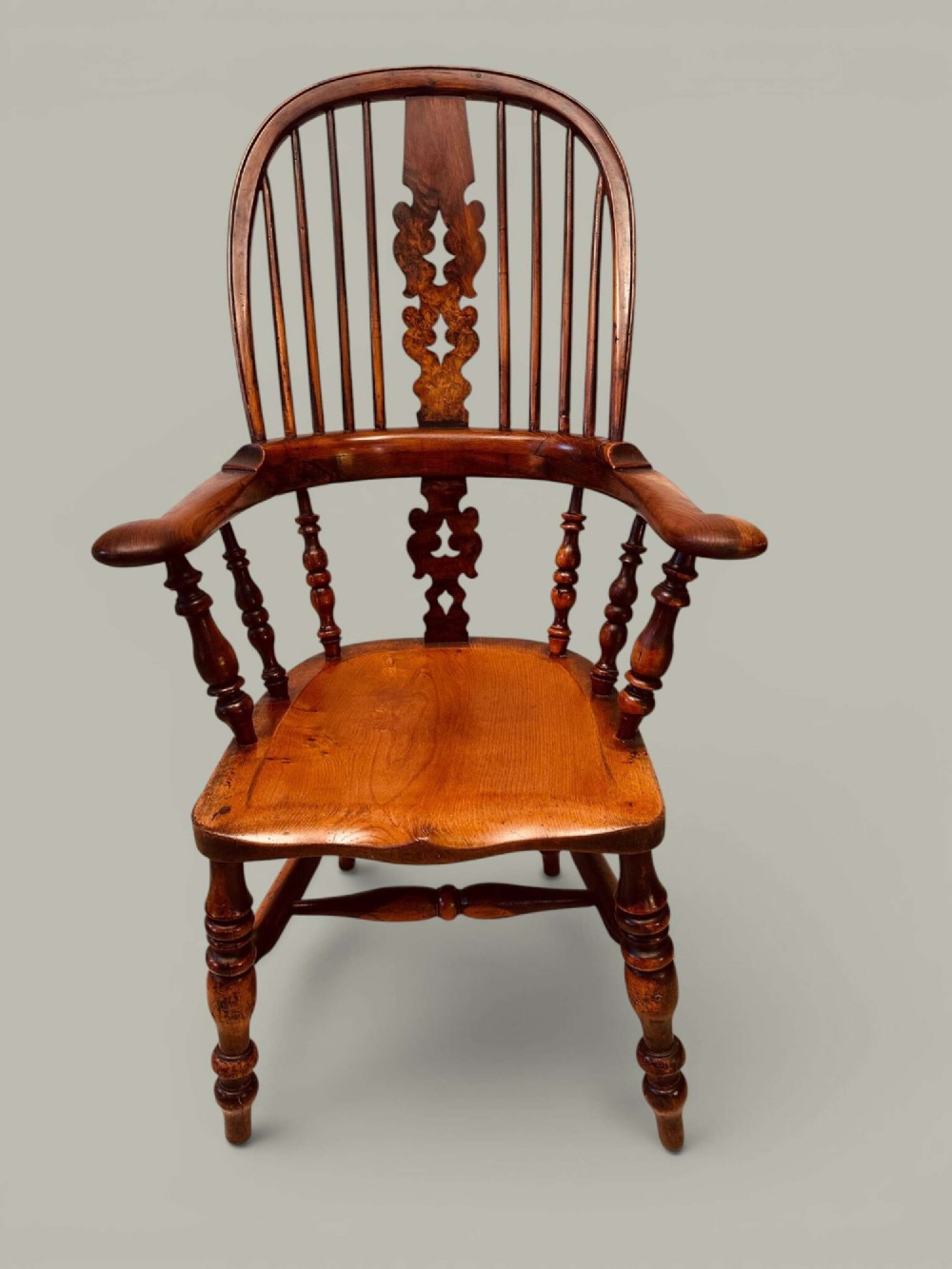A pair of 19th-century yew and elm Windsor armchairs featuring curved hoop backs, pierced central splats, broad armrests, and turned legs. View XI