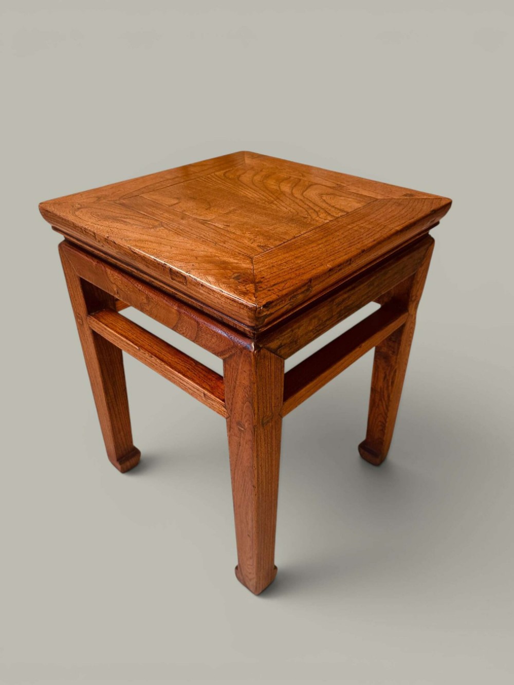 A near pair of square late 19th-century Chinese elm side tables with panelled tops, straight legs, and stretchers in a warm brown timber finish. View II
