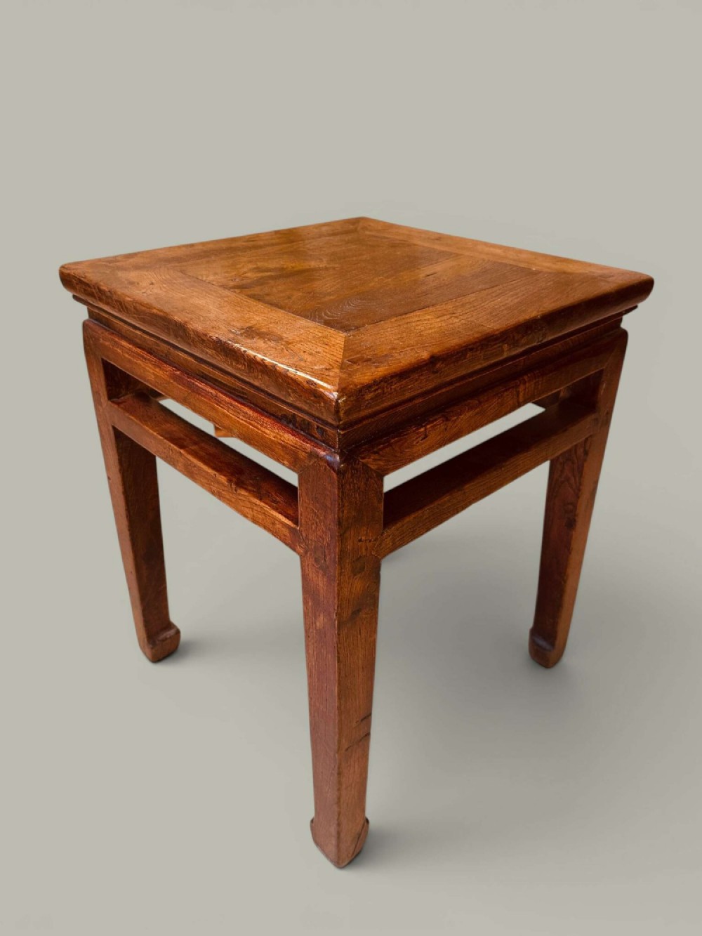 A near pair of square late 19th-century Chinese elm side tables with panelled tops, straight legs, and stretchers in a warm brown timber finish. View III