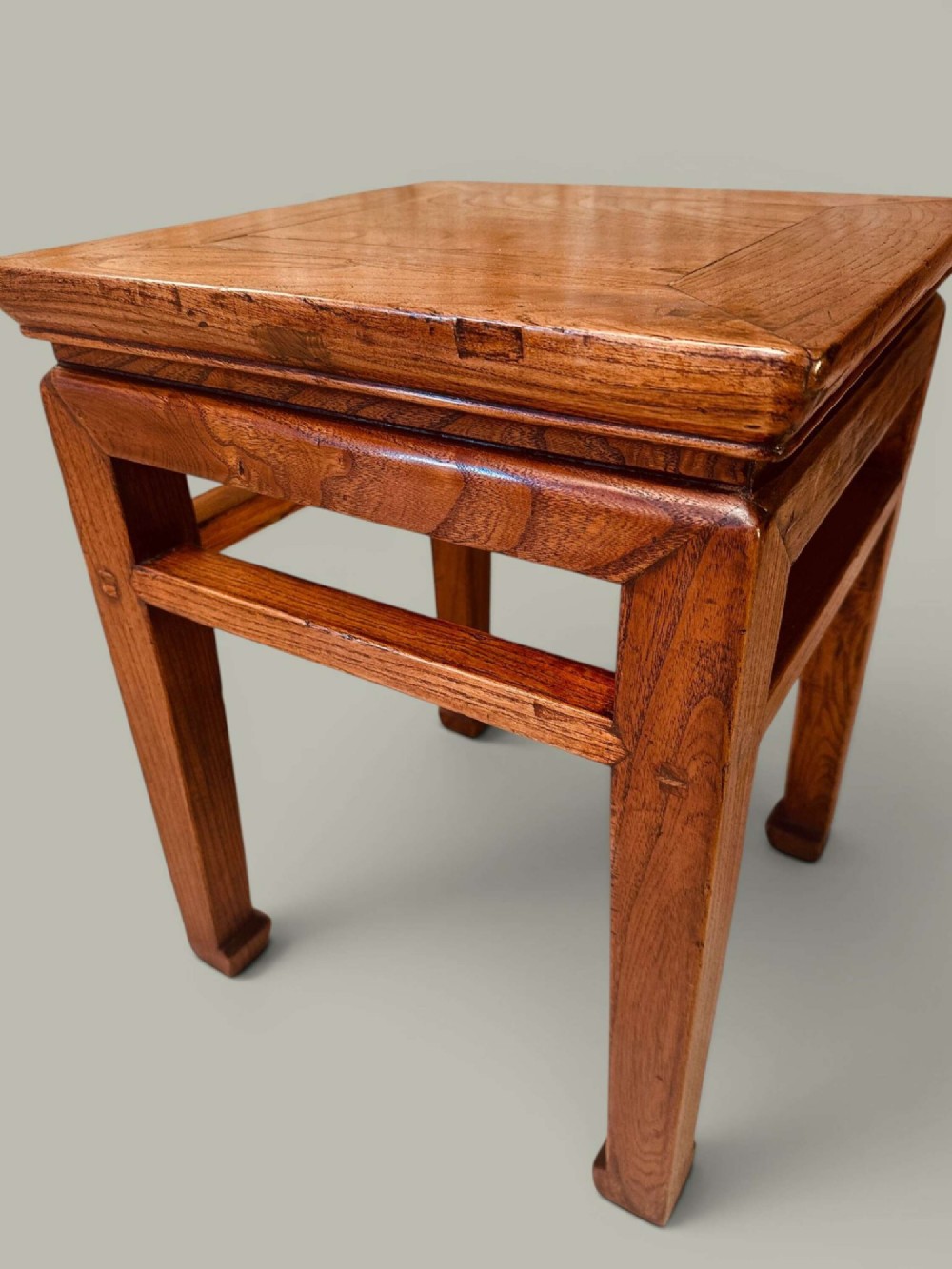 A near pair of square late 19th-century Chinese elm side tables with panelled tops, straight legs, and stretchers in a warm brown timber finish. View IV