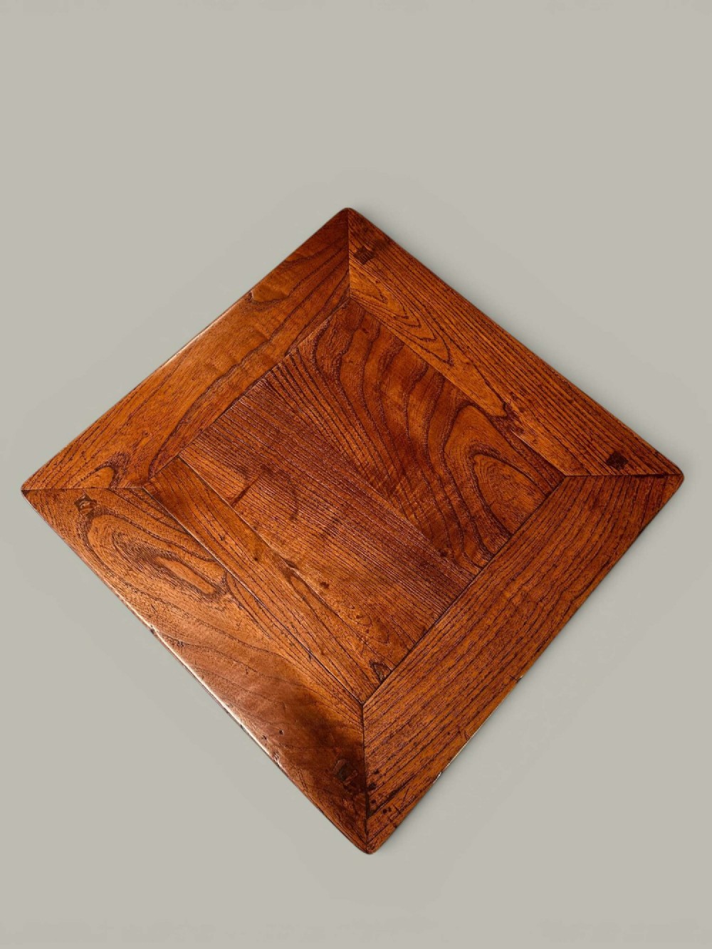 A near pair of square late 19th-century Chinese elm side tables with panelled tops, straight legs, and stretchers in a warm brown timber finish. View VI