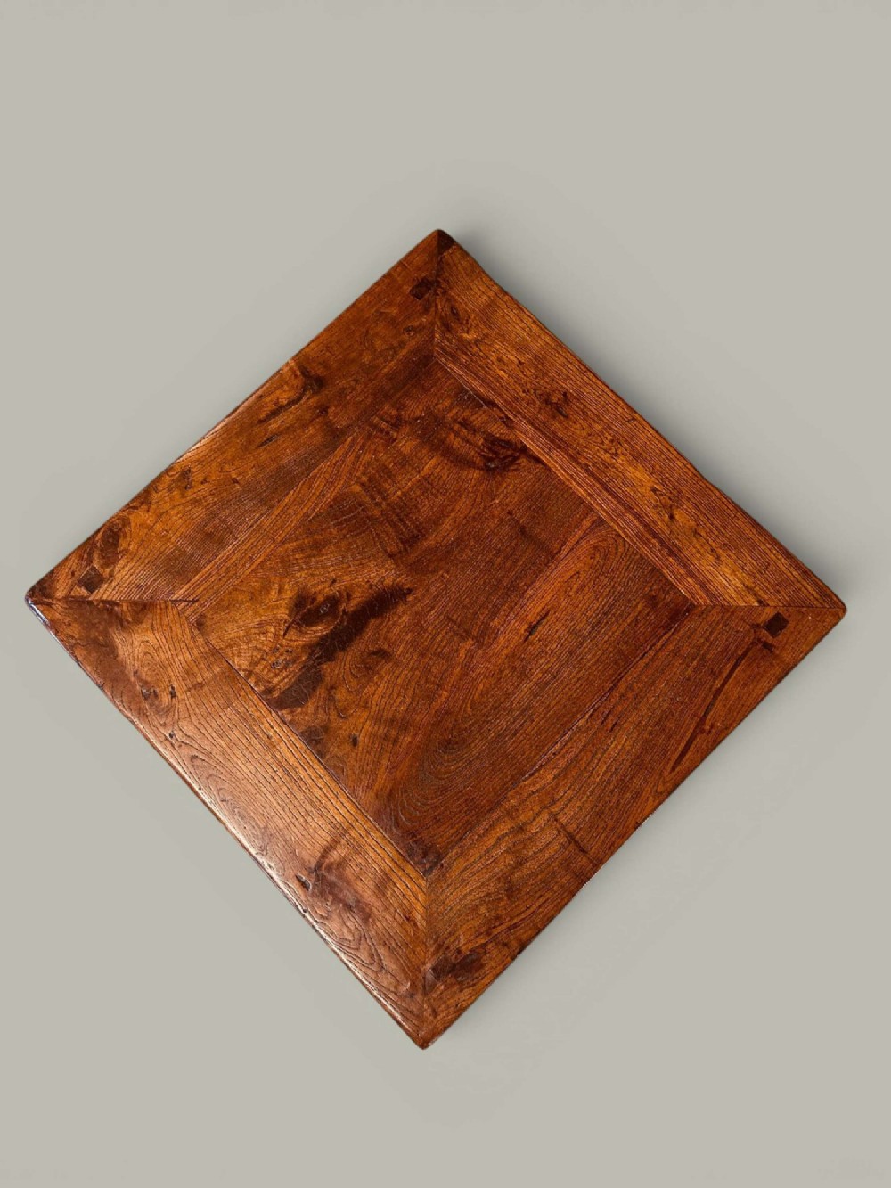 A near pair of square late 19th-century Chinese elm side tables with panelled tops, straight legs, and stretchers in a warm brown timber finish. View VII