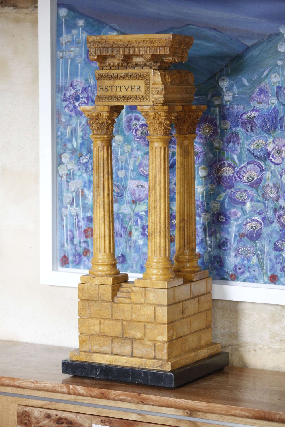 A 19th-century Grand Tour sienna marble architectural model depicting three fluted Corinthian columns of the Temple of Vespasian mounted on a black marble base.