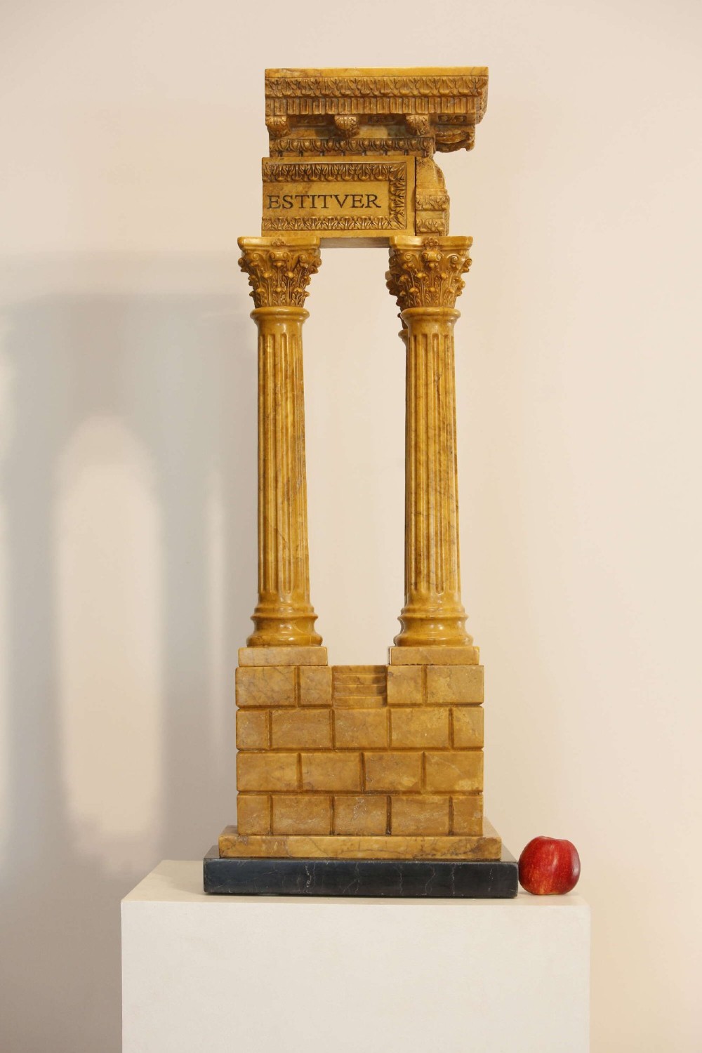 A 19th-century Grand Tour sienna marble architectural model depicting three fluted Corinthian columns of the Temple of Vespasian mounted on a black marble base. View III