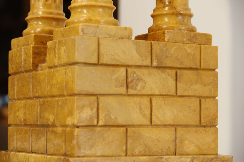 A 19th-century Grand Tour sienna marble architectural model depicting three fluted Corinthian columns of the Temple of Vespasian mounted on a black marble base. View V