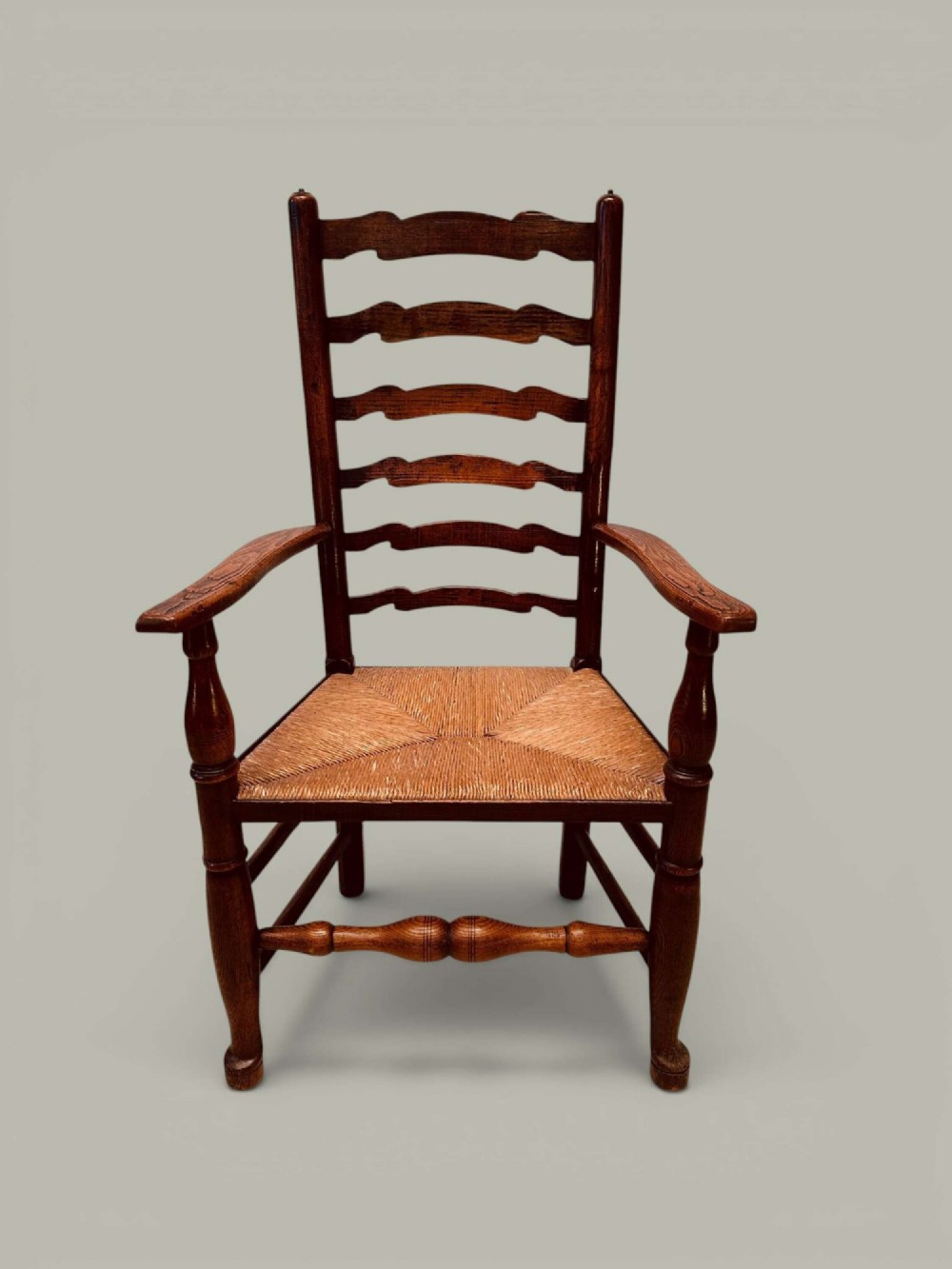 A set of eight antique ash dining chairs featuring wavy ladder backs, turned stretchers, and woven rush seats, comprising six side chairs and two carver armchairs. View VIII