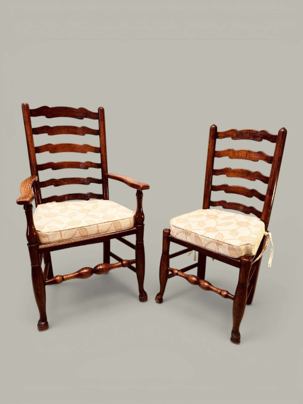 A set of eight antique ash dining chairs featuring wavy ladder backs, turned stretchers, and woven rush seats, comprising six side chairs and two carver armchairs. View XIV