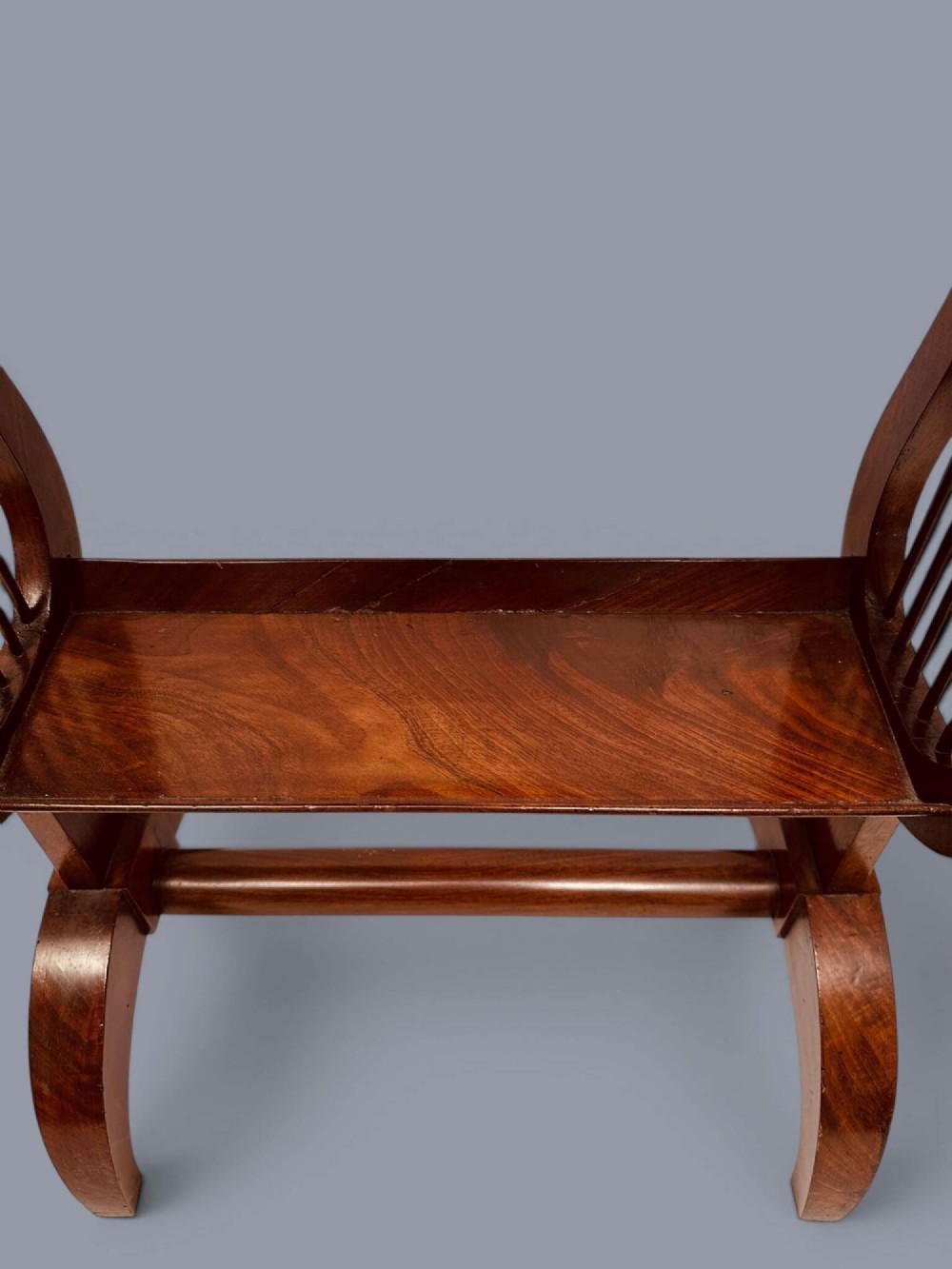 A Regency period mahogany tricoteuse table featuring a gallery top rim, lyre-shaped leg supports with vertical rods, a lower shelf, and splayed feet. View IX