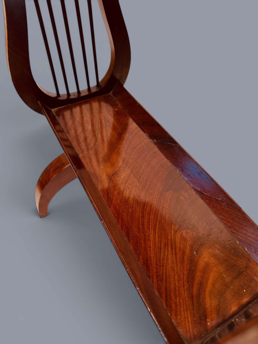 A Regency period mahogany tricoteuse table featuring a gallery top rim, lyre-shaped leg supports with vertical rods, a lower shelf, and splayed feet. View XIV