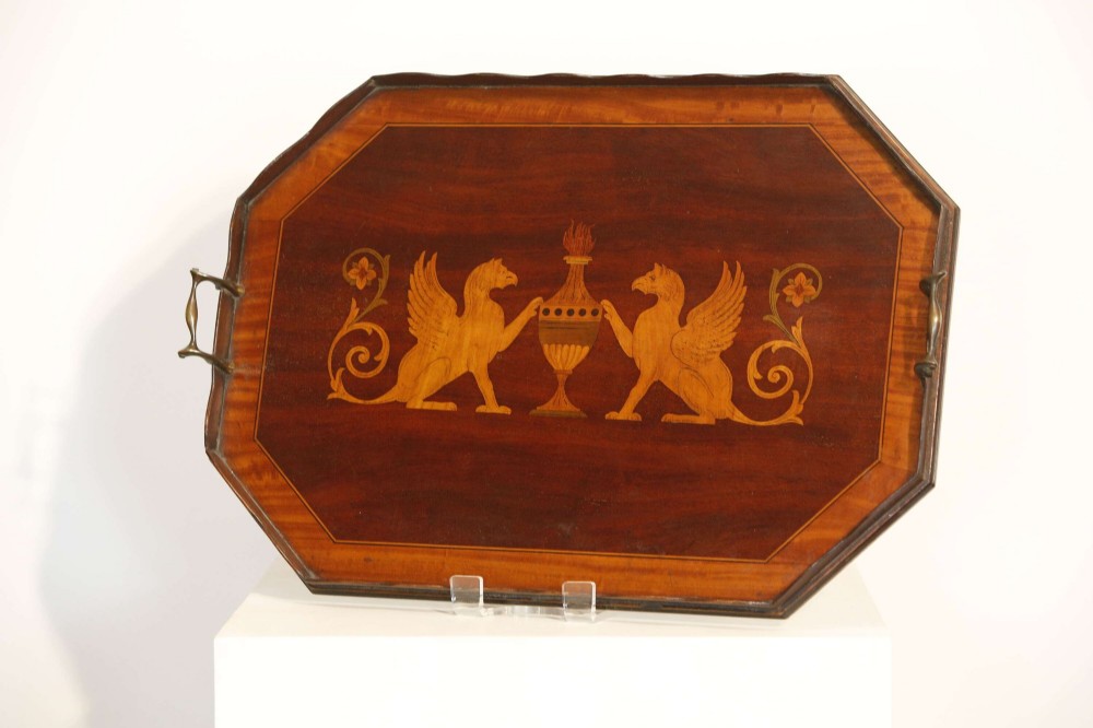 An octagonal mahogany serving tray featuring central marquetry inlay depicting twin winged griffins flanking a classical urn, with brass handles on two sides. View III