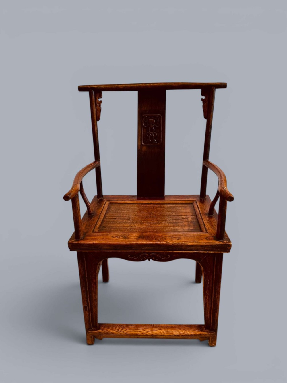 A pair of late nineteenth-century Chinese dark elm armchairs featuring carved central back splats and curved crest rails. View III
