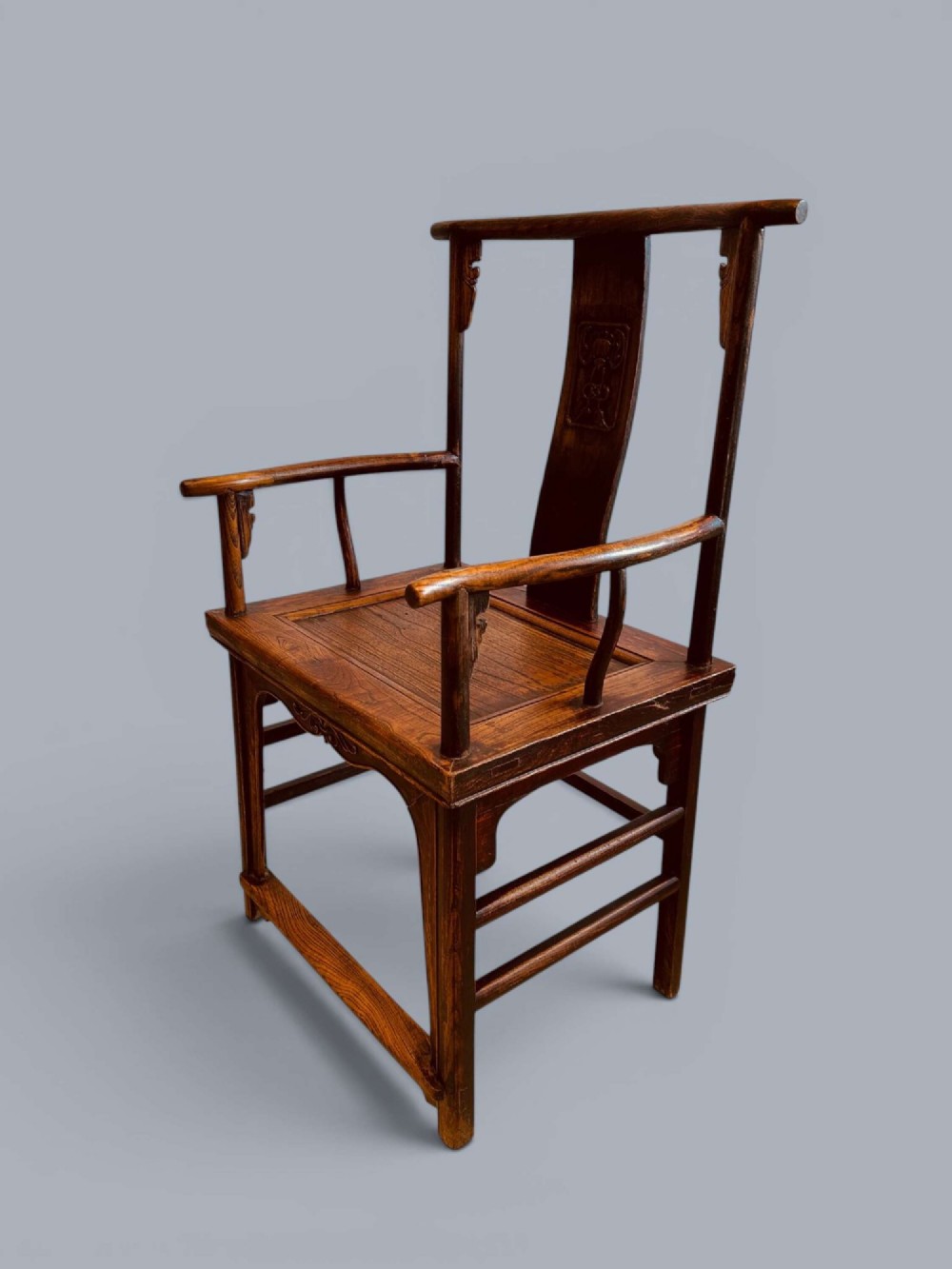 A pair of late nineteenth-century Chinese dark elm armchairs featuring carved central back splats and curved crest rails. View IV
