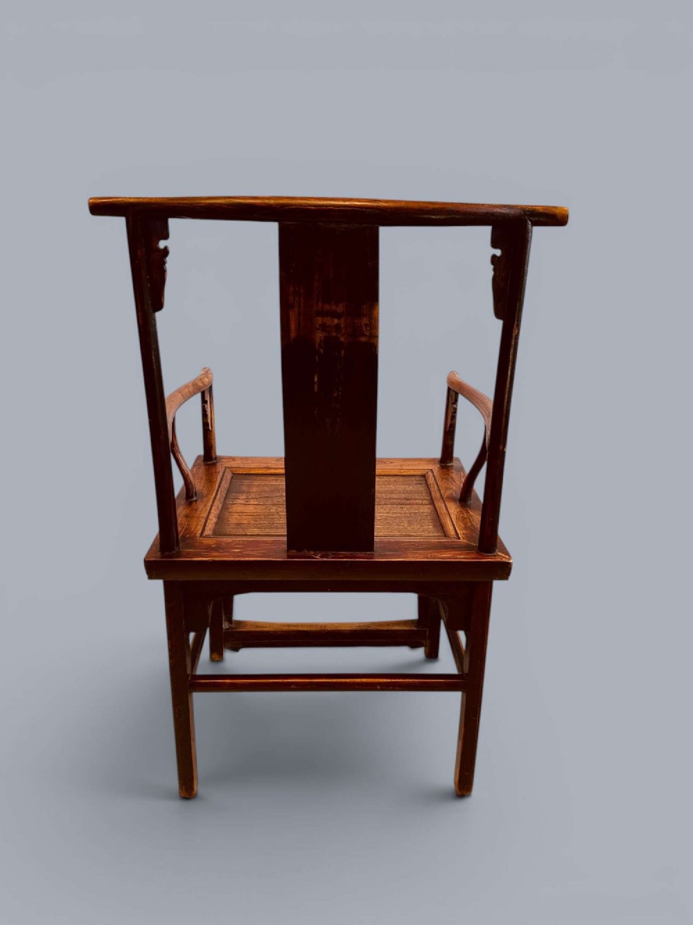 A pair of late nineteenth-century Chinese dark elm armchairs featuring carved central back splats and curved crest rails. View VI