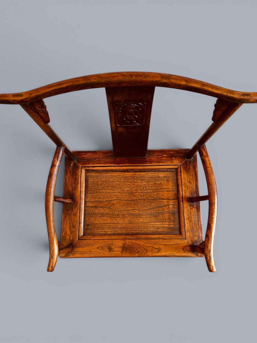 A pair of late nineteenth-century Chinese dark elm armchairs featuring carved central back splats and curved crest rails. View VII