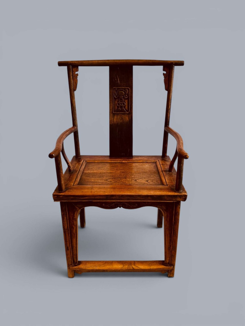 A pair of late nineteenth-century Chinese dark elm armchairs featuring carved central back splats and curved crest rails. View VIII