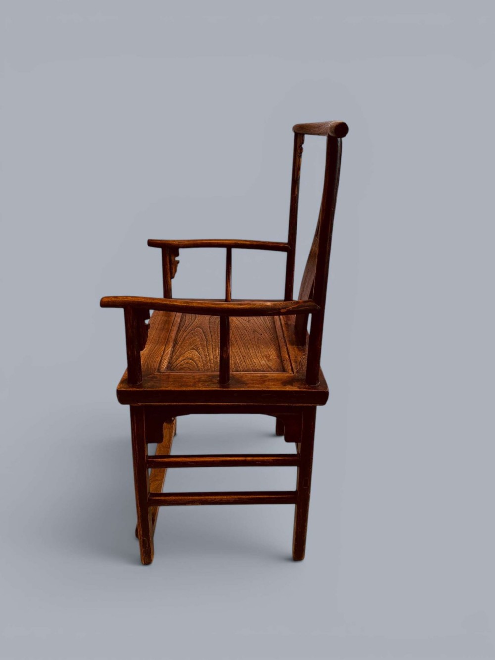 A pair of late nineteenth-century Chinese dark elm armchairs featuring carved central back splats and curved crest rails. View IX