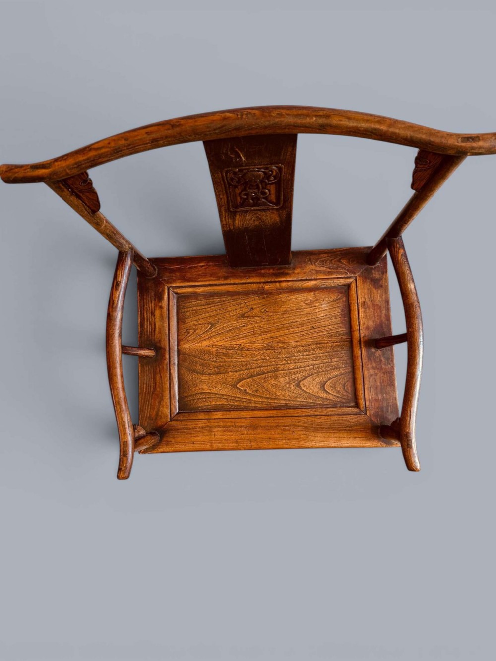 A pair of late nineteenth-century Chinese dark elm armchairs featuring carved central back splats and curved crest rails. View XI