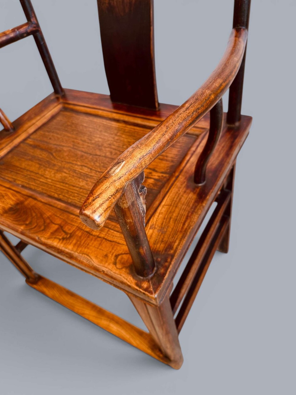 A pair of late nineteenth-century Chinese dark elm armchairs featuring carved central back splats and curved crest rails. View XIII