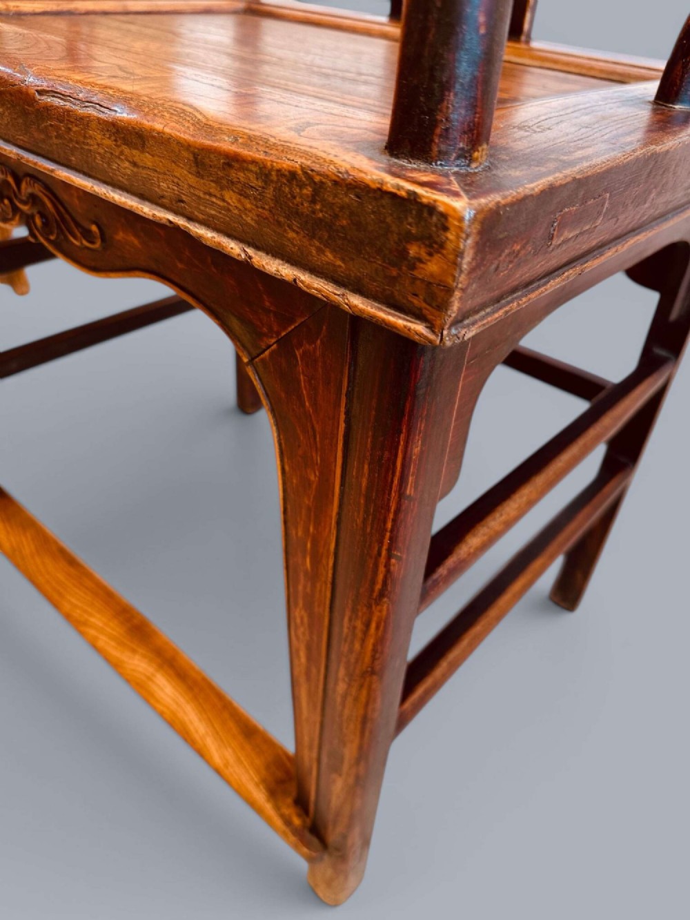 A pair of late nineteenth-century Chinese dark elm armchairs featuring carved central back splats and curved crest rails. View XIV