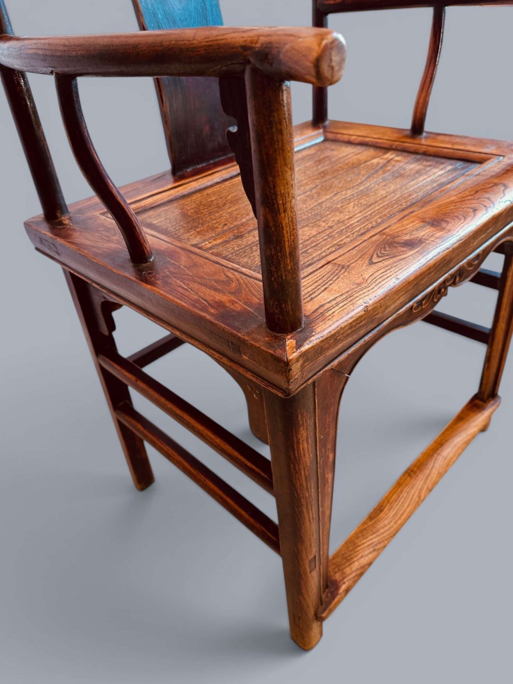 A pair of late nineteenth-century Chinese dark elm armchairs featuring carved central back splats and curved crest rails. View XV
