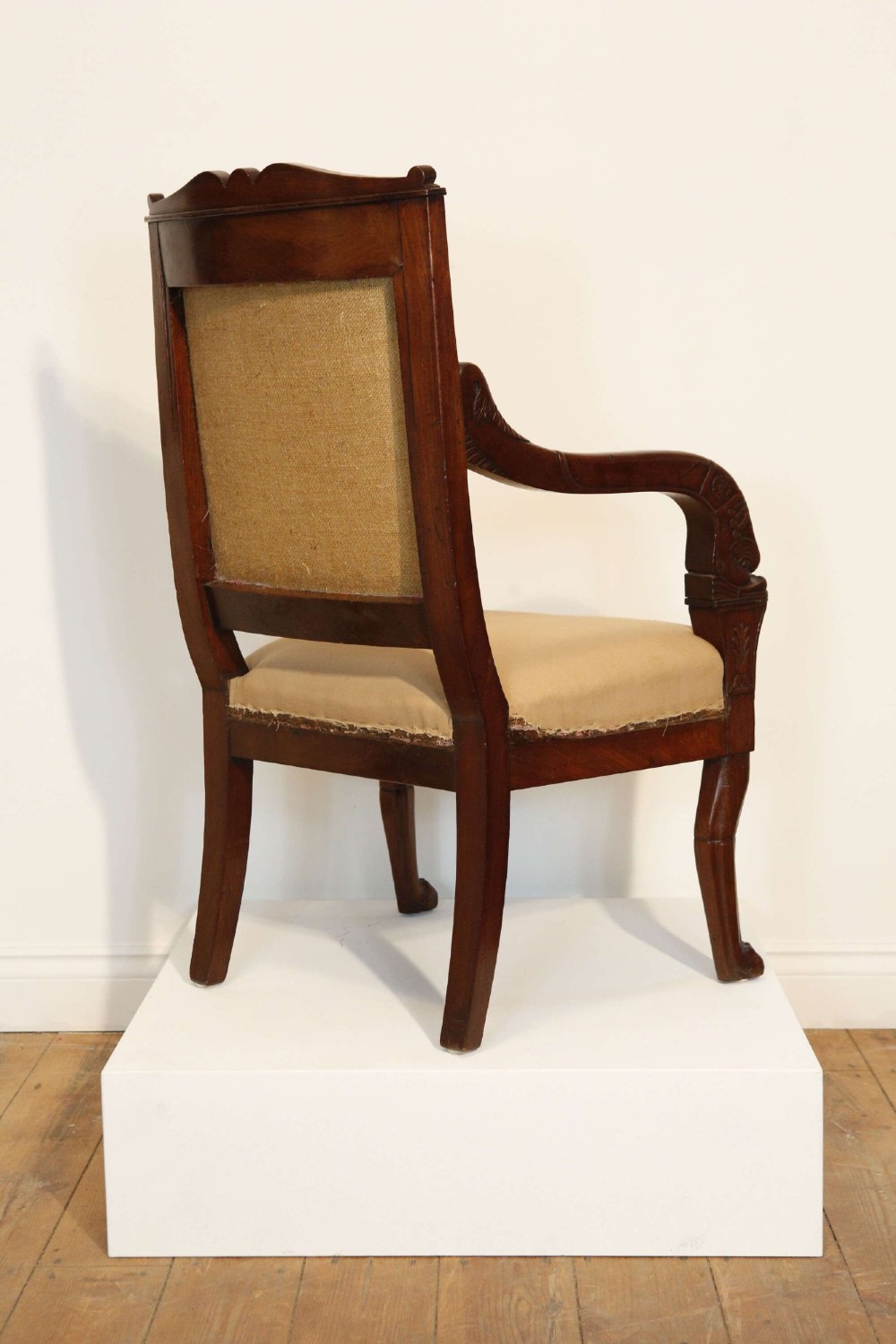 An early nineteenth-century French Empire carved mahogany armchair with padded seat and backrest, curved arms, and carved front legs. View VIII