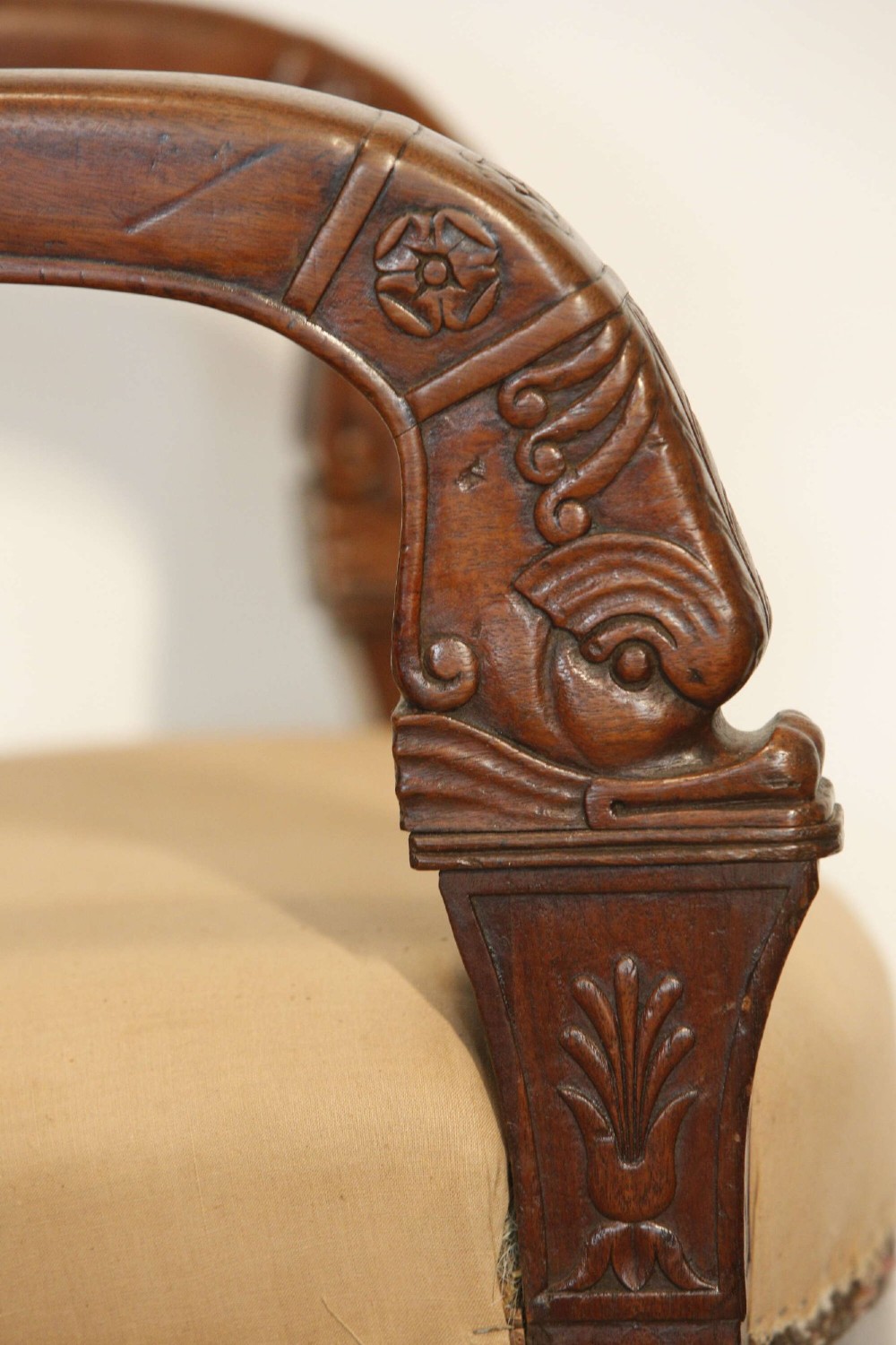 An early nineteenth-century French Empire carved mahogany armchair with padded seat and backrest, curved arms, and carved front legs. View XII