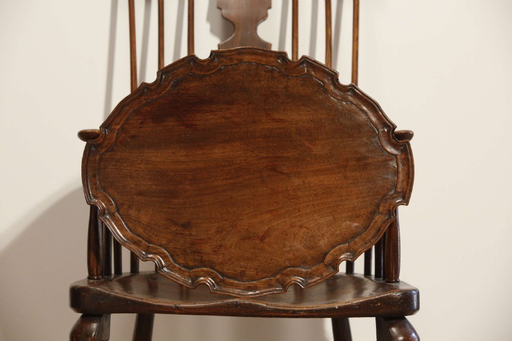 A George III mahogany oval tray featuring a hand-carved pie crust scalloped rim and rich wood grain. View VIII