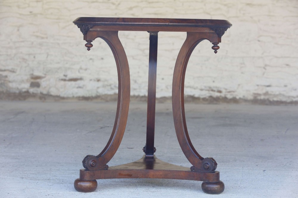 A circular 19th-century French gueridon table featuring a dark green marble top supported by three curved mahogany legs resting on a shaped triform base. View XI