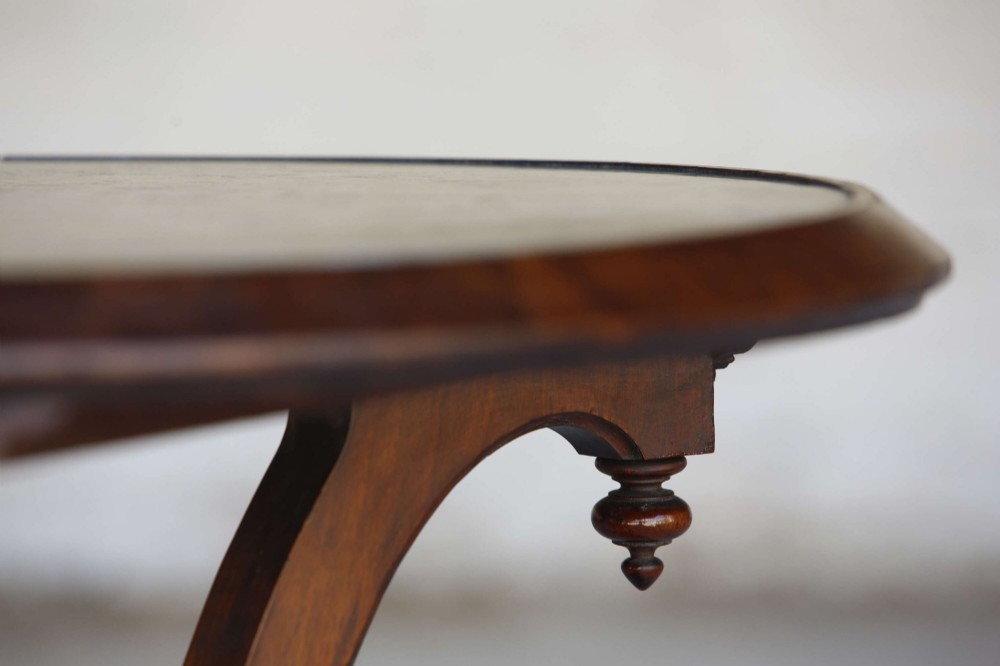 A circular 19th-century French gueridon table featuring a dark green marble top supported by three curved mahogany legs resting on a shaped triform base. View XII