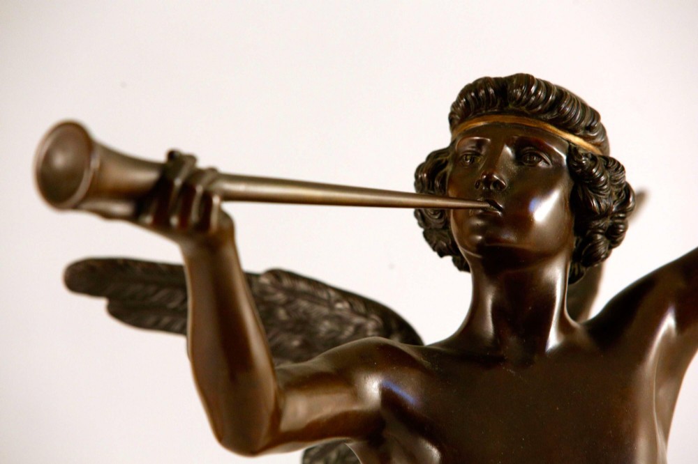 A 19th-century dark brown patinated bronze sculpture depicting the winged Archangel Gabriel blowing a trumpet raised on a round base. View XIII