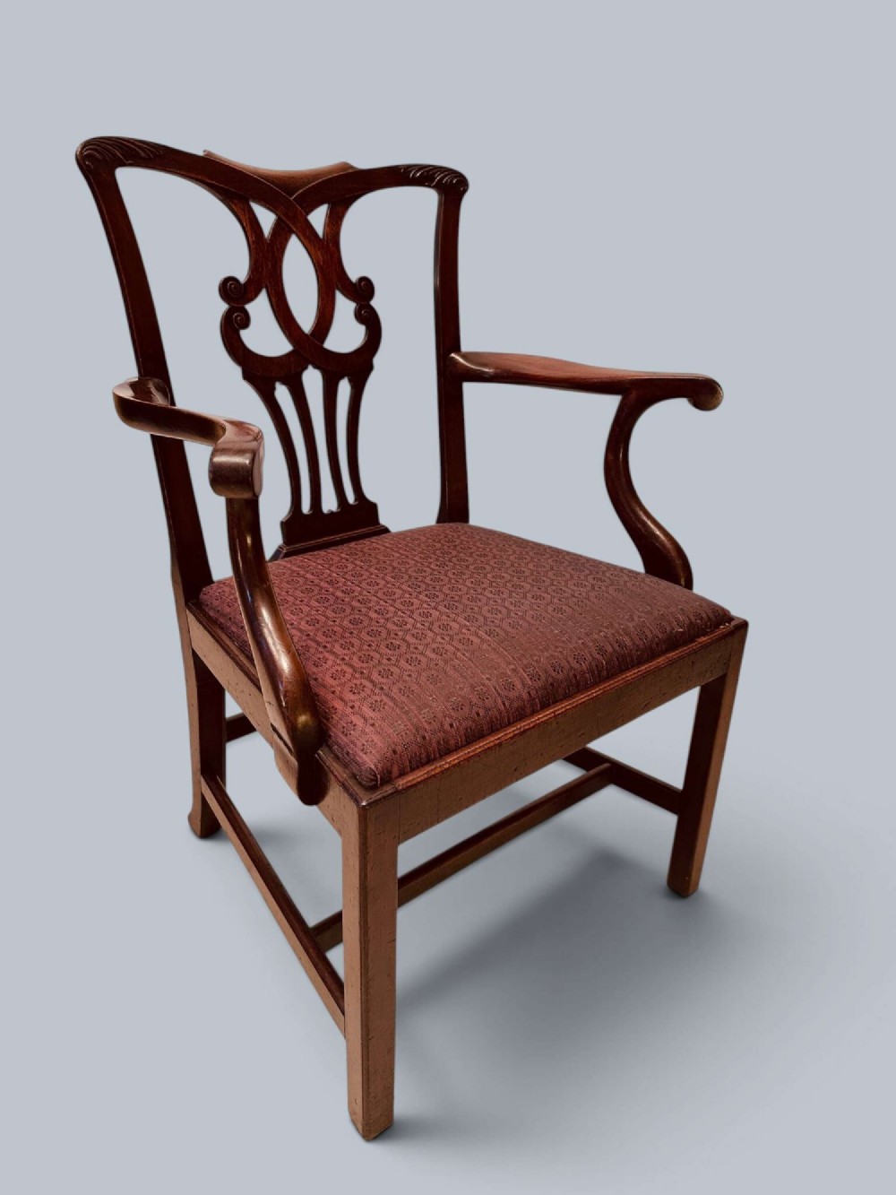 A pair of 19th-century mahogany Chippendale style armchairs featuring carved pierced splat backs, curving armrests, and patterned fabric seats. View II