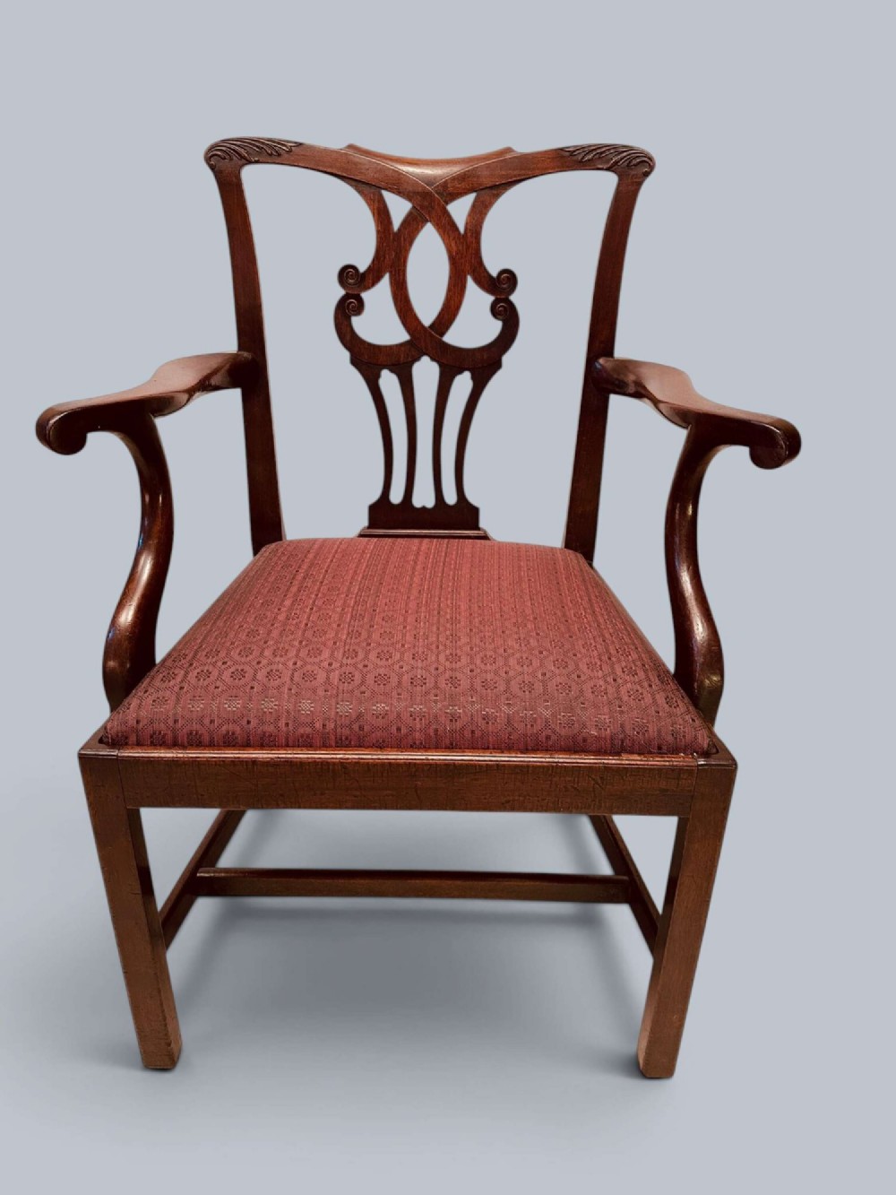 A pair of 19th-century mahogany Chippendale style armchairs featuring carved pierced splat backs, curving armrests, and patterned fabric seats. View III