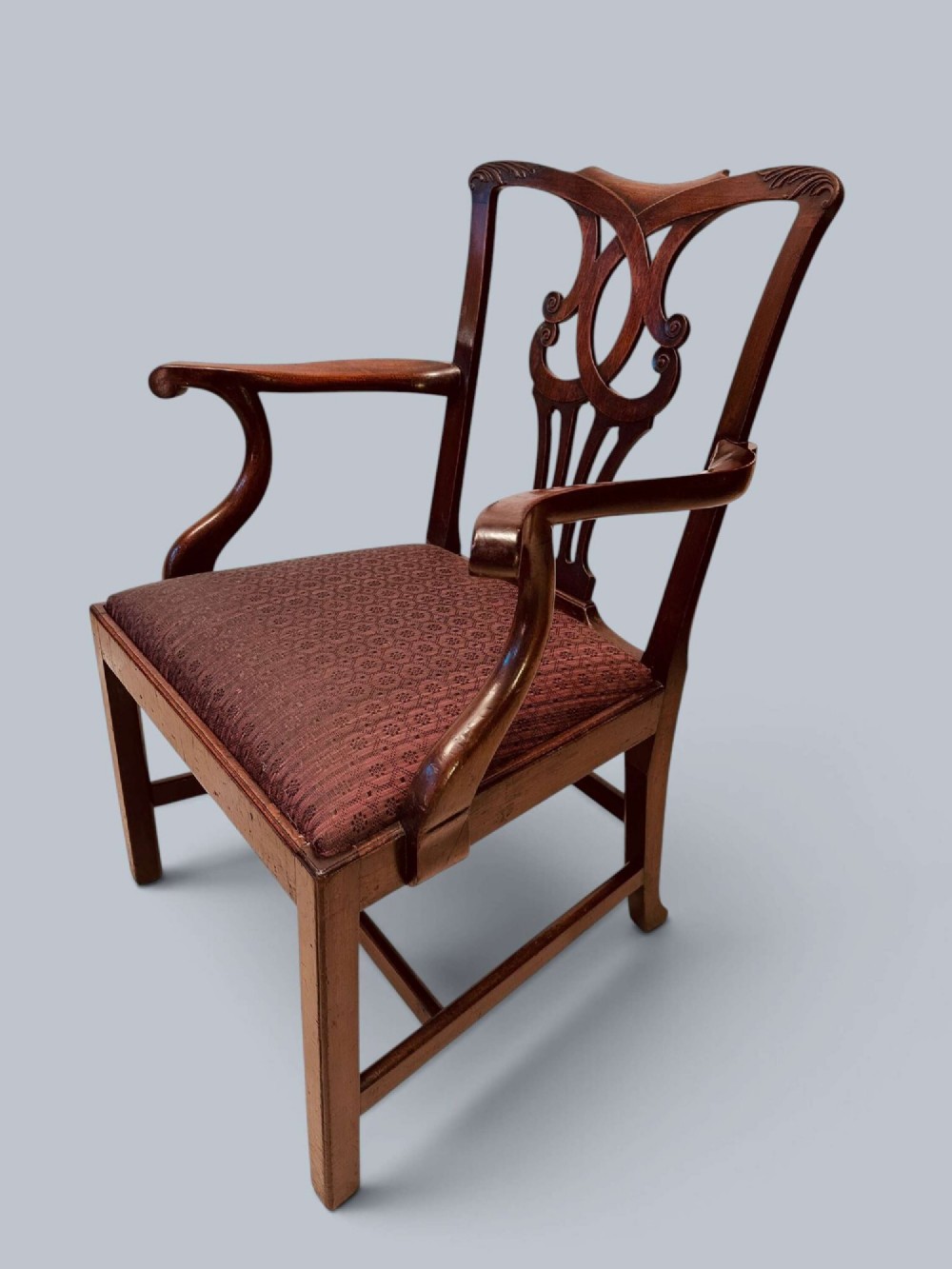 A pair of 19th-century mahogany Chippendale style armchairs featuring carved pierced splat backs, curving armrests, and patterned fabric seats. View IV