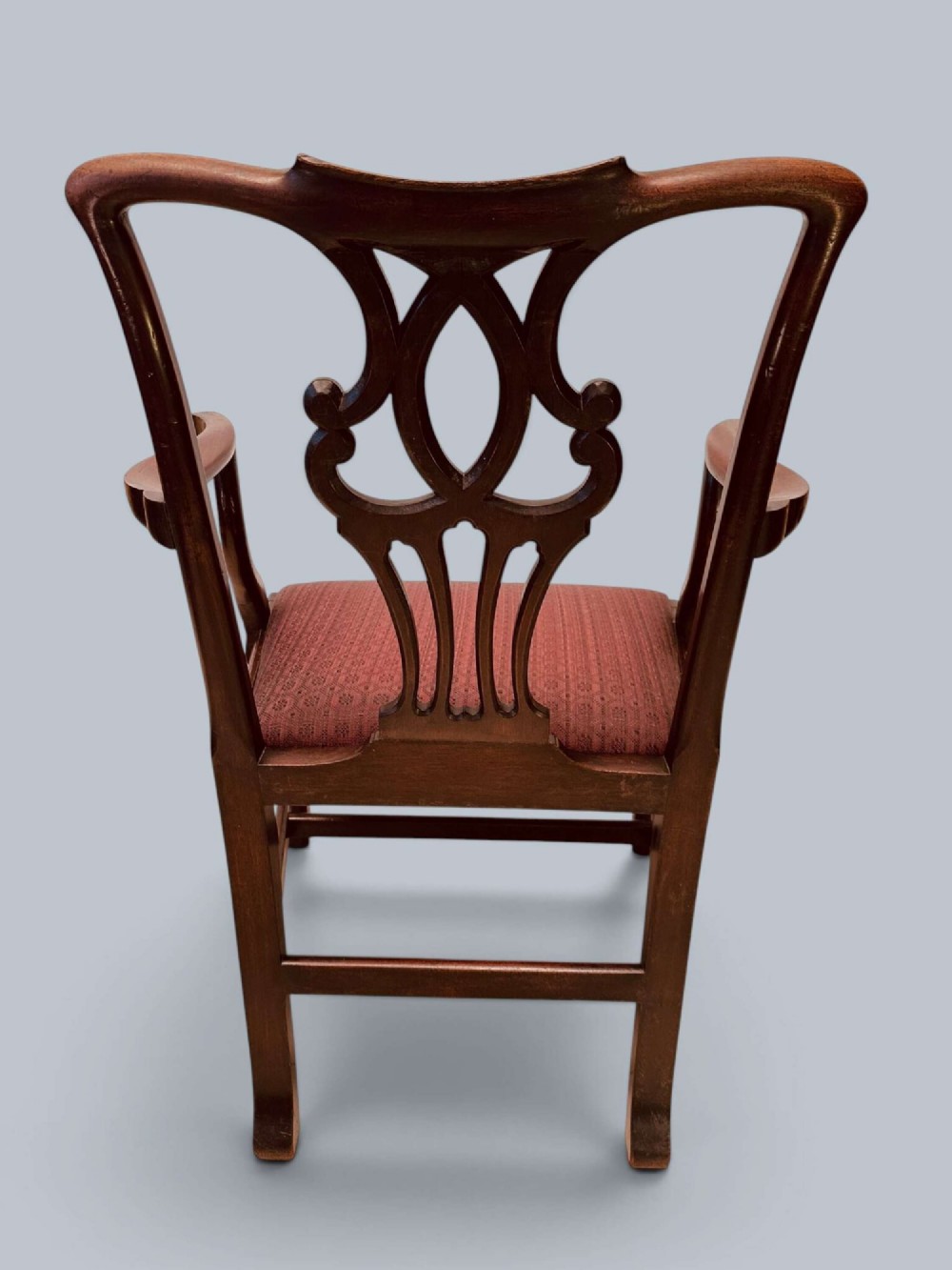 A pair of 19th-century mahogany Chippendale style armchairs featuring carved pierced splat backs, curving armrests, and patterned fabric seats. View VI