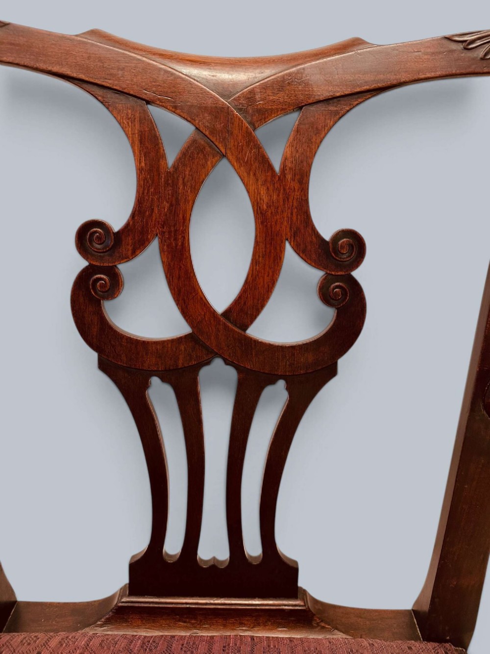 A pair of 19th-century mahogany Chippendale style armchairs featuring carved pierced splat backs, curving armrests, and patterned fabric seats. View VII