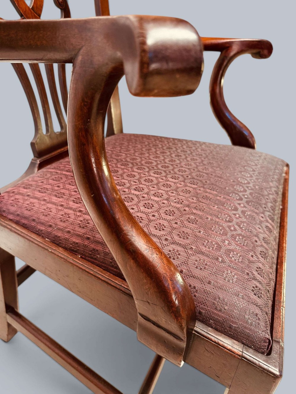 A pair of 19th-century mahogany Chippendale style armchairs featuring carved pierced splat backs, curving armrests, and patterned fabric seats. View VIII