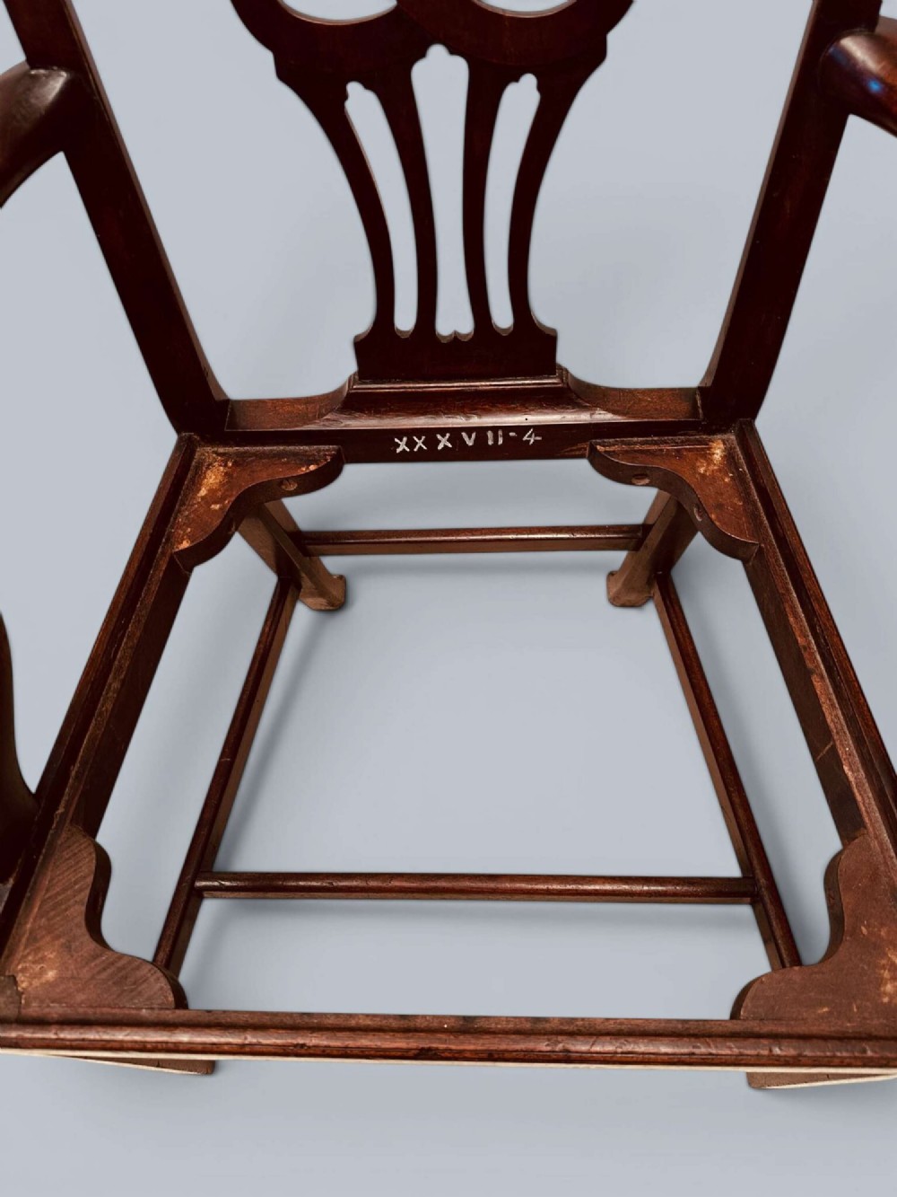 A pair of 19th-century mahogany Chippendale style armchairs featuring carved pierced splat backs, curving armrests, and patterned fabric seats. View XI