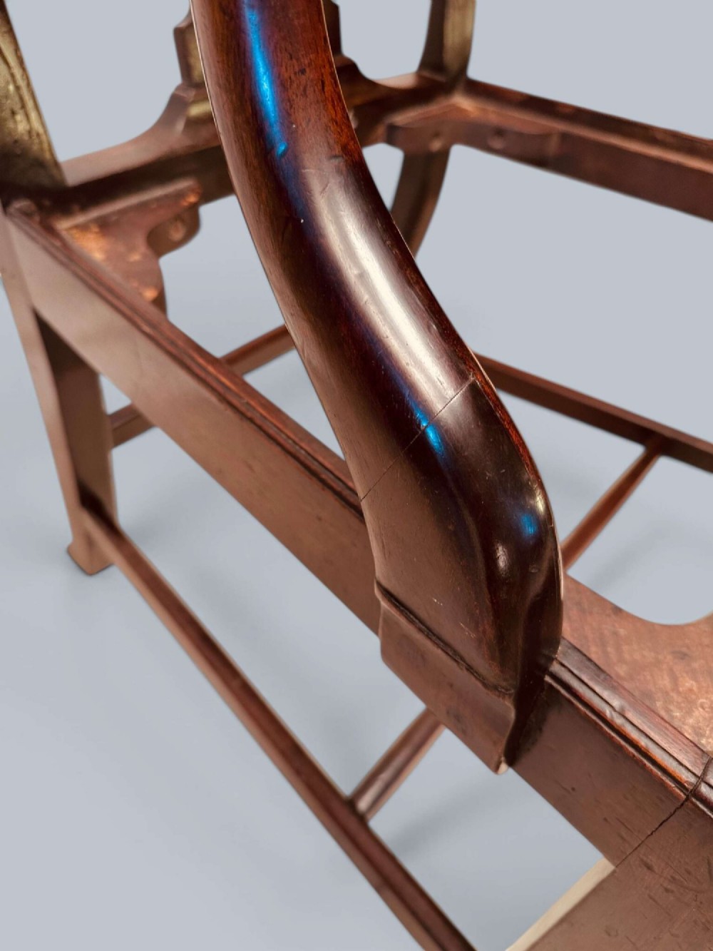 A pair of 19th-century mahogany Chippendale style armchairs featuring carved pierced splat backs, curving armrests, and patterned fabric seats. View XII