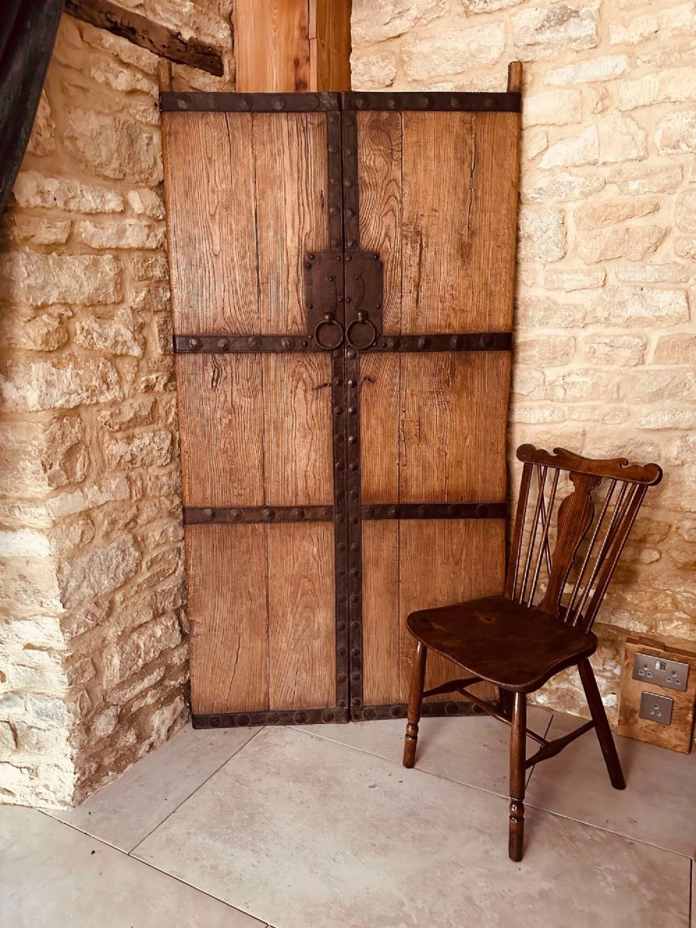 Pair of late nineteenth-century reclaimed Chinese elm doors featuring heavy iron strapping, metal studs, and central ring handles. View II
