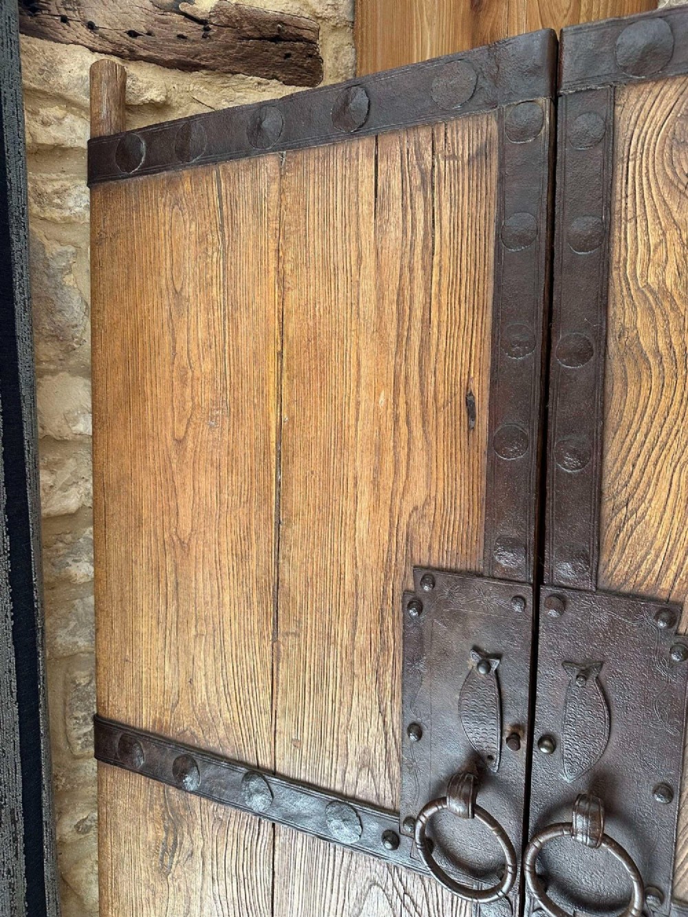 Pair of late nineteenth-century reclaimed Chinese elm doors featuring heavy iron strapping, metal studs, and central ring handles. View IV