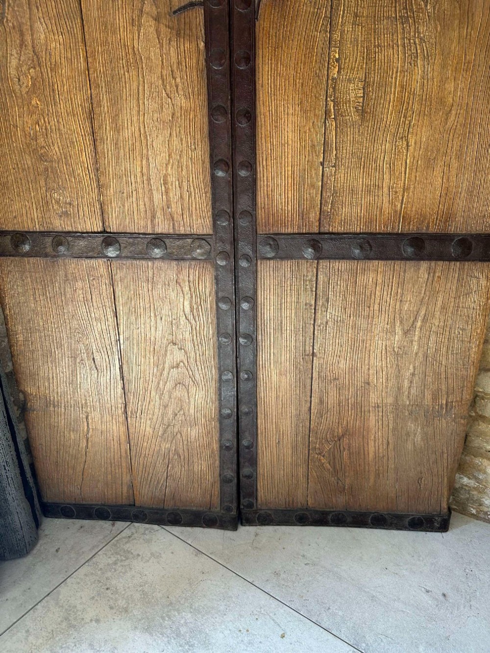 Pair of late nineteenth-century reclaimed Chinese elm doors featuring heavy iron strapping, metal studs, and central ring handles. View VII